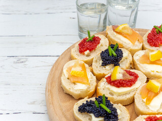 fish roe appetizers with glasses with vodka aside