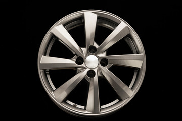 grey alloy wheel, modern auto parts. black background front view