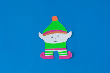 Step 11. Step-by-step instructions on how to make an elf out of colored paper and cardboard. DIY concept. Children's art project. Craft from colored paper for Christmas, St. Patrick's Day.