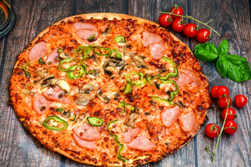  Close up of    hot italian pizza   classic ham. Fresh basil,tomato sauce ,mozzarella cheese , mushrooms and  minced meat .Concept poster for Restaurants or pizzerias. Top view