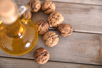 A bottle of walnut oil and a few walnuts
