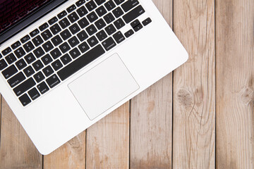 Laptop on wood grain background