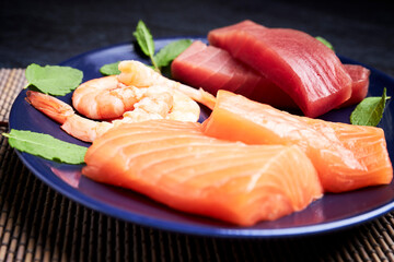 Plate with salmon, tuna and shrimp to make sushi. Delicious Japanese food