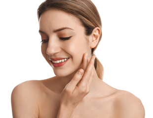 Young woman applying facial cream on white background