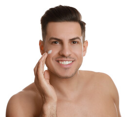 Handsome man applying face cream on white background