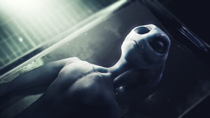 3D Rendering, illustration of a dead alien on an autopsy gurney in a dramatic lit morgue. high contrast image. © fergregory