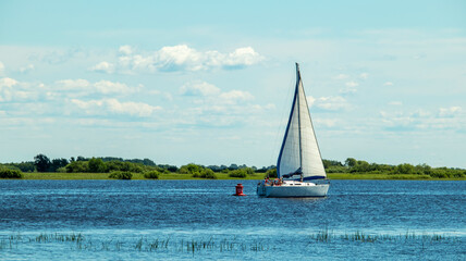 Obraz premium a large white yacht floats upstream on a sunny day