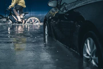 Foto op Aluminium car in a deep puddle. downpour in the city. flooded car. flood in the city. © Андрей К