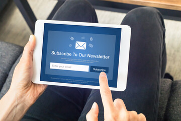 Subscribe to newsletter form on tablet computer screen to join list of susbscribers and receive...