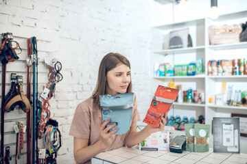 Young girl choosing food for her pet in a pet store