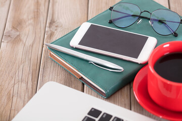 Various daily office supplies on wooden background