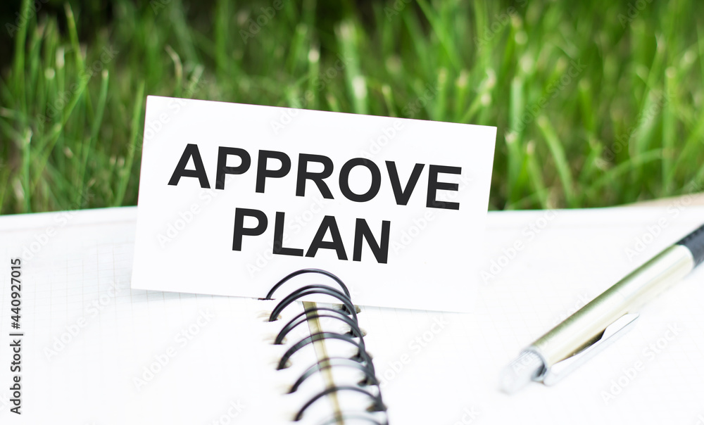 Poster white card with approve plan text on open notebook