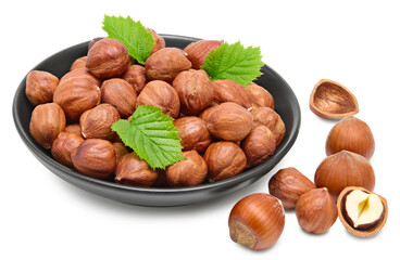 hazelnuts in black bowl isolated on white background macro. clipping path