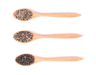 Black pepper and ground pepper in wooden spoon isolated on white background