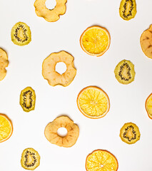 The dry pieces of different fruits in a row to fresh fruits