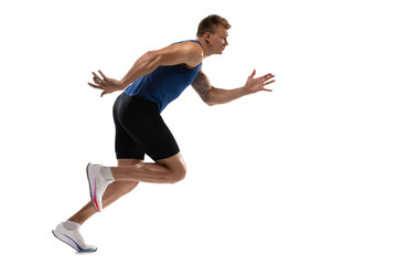 Caucasian professional male athlete, runner training isolated on white studio background. Muscular,...
