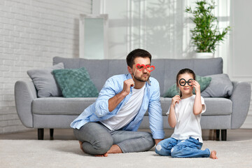 Obraz premium dad and little kid girl holding paper glasses
