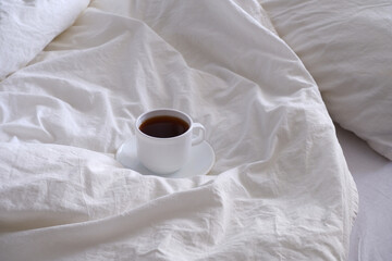 Breakfast in bed. White linens. Coffee  in bed.