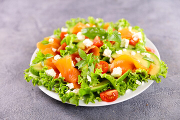 vegetable salad with smoked salmon,  tomato and feta cheese