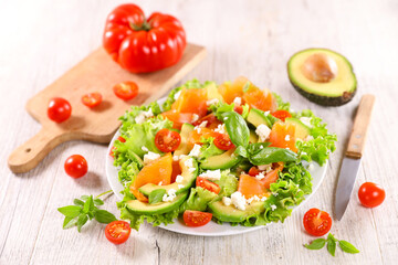 vegetable salad with smoked salmon,  tomato and avocado