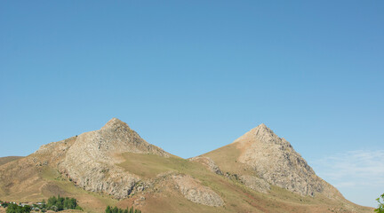 dual hill and blue sky view.