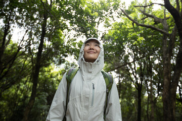 Woman backpacker hiking in spring forest