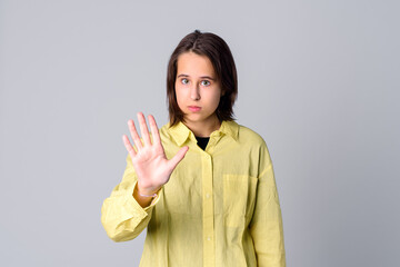No. Serious teen girl show stop prohibit gesture, keep your distance, stay away back off sign