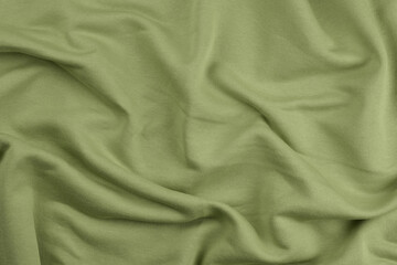 Obraz premium Background from green monochrome cotton fabric. Close up texture of the fabric is useful as a background.