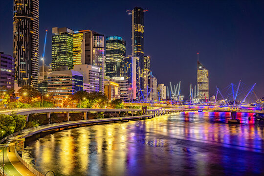 Brisbane, Australia - City illuminated at night with Kurilpa bridge across the river