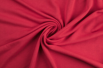 Background from red monochrome cotton fabric. Close up texture of the fabric is useful as a background.