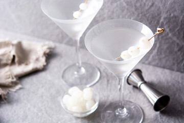 Gibson martini cocktail with onions on gray stone. Copy space