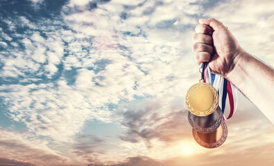 Hand with medals celebrating Olympic games success