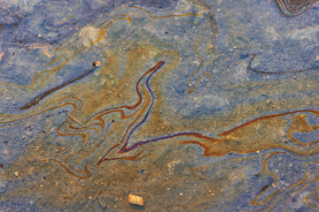 spilled gasoline rainbow background, industrial hazard spill pollution, abstract texture multicolored