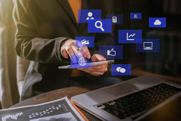 Social media and Marketing virtual icons screen of business women typing keyboard with tablet and laptop computer at office.