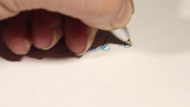 Hand writing Thank You in blue cursive