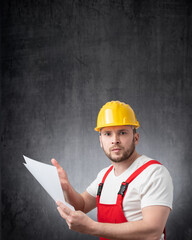 An angry construction worker holding papers or documents