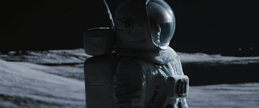 MID Portrait of Asian lunar astronaut opens his visor while exploring Moon surface. Shot with 2x anamorphic lens