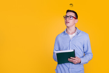 A handsome guy in a blue shirt on a yellow background