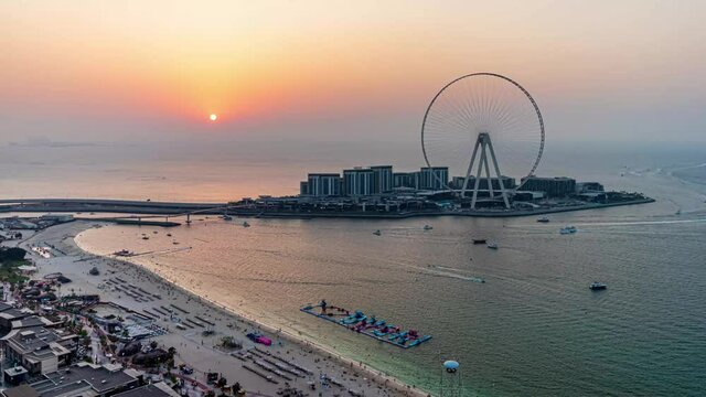 DUBAI, UNITED ARAB EMIRATES - Oct 31, 2019: This is an aerial timelapse video of the Bluewaters Island and Dubai Eye Observation Wheel during sunset.