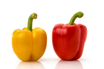 Two red and yellow bell peppers isolated on white