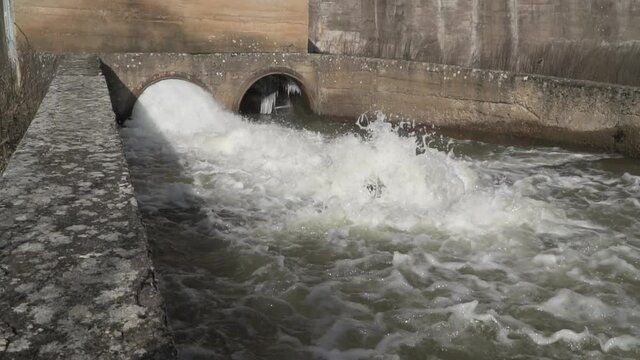 Dam discharge pipes, drainage with rapis water flowing during the flood period. Slow motion