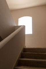Modern east style building with beige walls, windows and sunlight shadows. Aesthetic abstract...