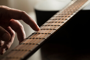 man playing guitar. Music. Guitar. Photo. Music concept. Photo. Light. Play. Rock