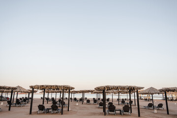 Beautiful lounge pavilion canopy for relax on the beach with sand and sea side view and blue sky