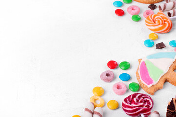 Sweets assortment on white table. Various confectionery products. Multicolored sweets and cookies....