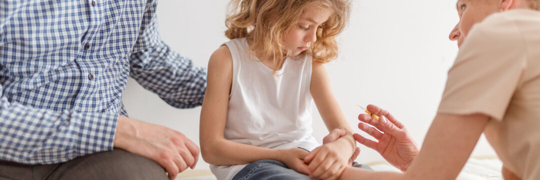 Caring father with cute little son during appointment with pedia