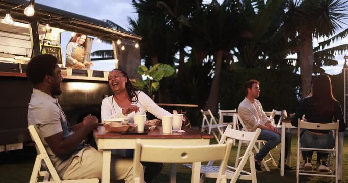 African mother and son eating food truck food dinner outdoor - Family and summer concept 
