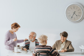 Senior people eating together