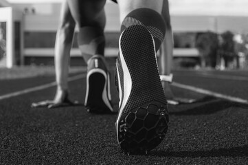 Image of spiked shoes at the start line of the track. Running concept.