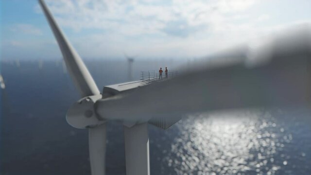 Workers on top of an offshore wind turbine against morning sun, low dof 4K